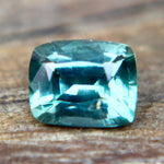 Side profile of a loose green sapphire showing its crown and pavilion