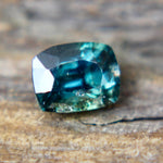 Side profile of a loose cushion-cut sapphire showing its crown and pavilion