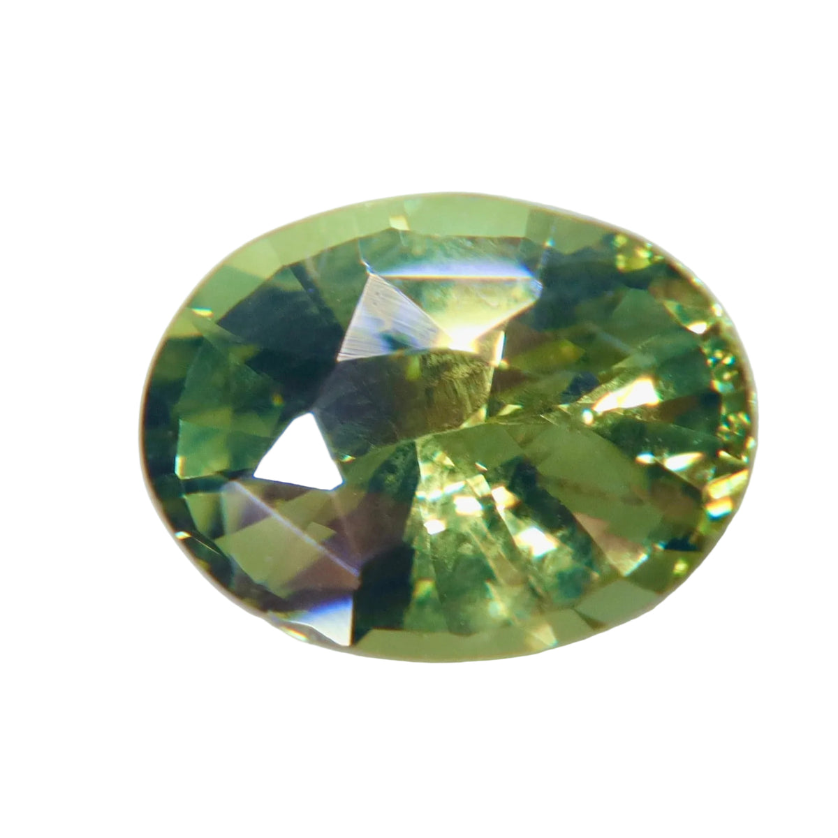 Face-up view of a 1.60 ct oval Ceylon alexandrite showing green tones and facet reflections.