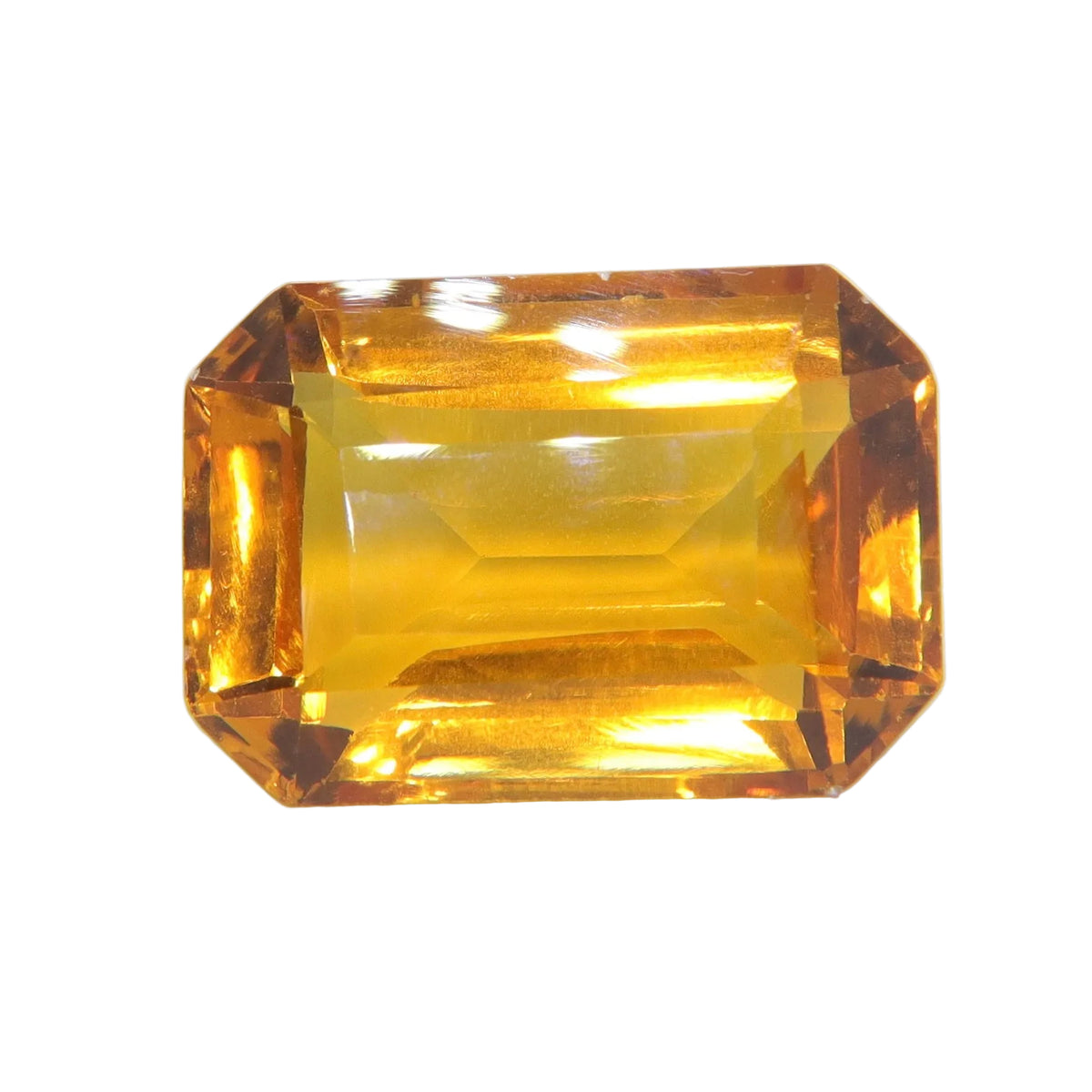 Face-up view of a 27.82 carat golden citrine with an emerald cut and clipped corners