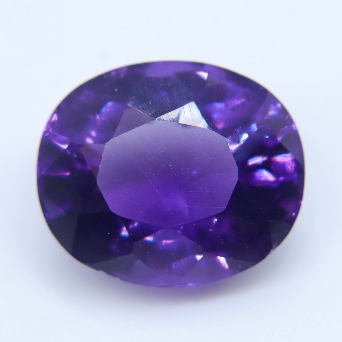 Side profile of an oval amethyst showing its crown and pavilion