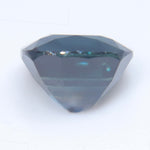 Angled view of natural deep blue cushion sapphire showing its facets
