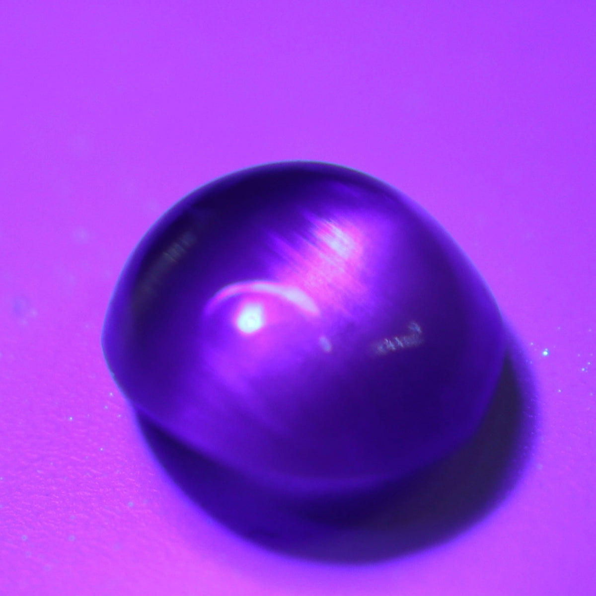 Angled view of the oval cabochon showing its curved profile