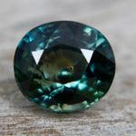 Back view of the natural green sapphire displaying its oval faceting
