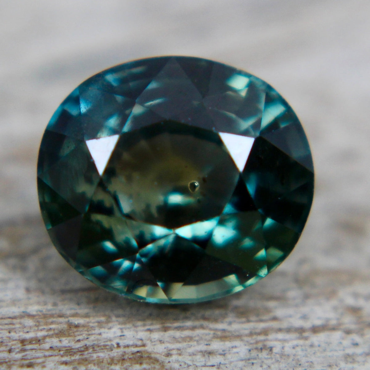 Back view of the natural green sapphire displaying its oval faceting