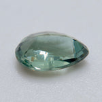 The same 1.54 ct Ceylon alexandrite photographed under two light sources for color comparison.