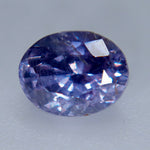 Close-up of an included oval purple sapphire showing its table and surrounding facets