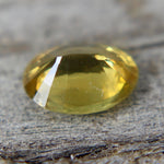 Close-up of an oval yellow sapphire showing its polished facets