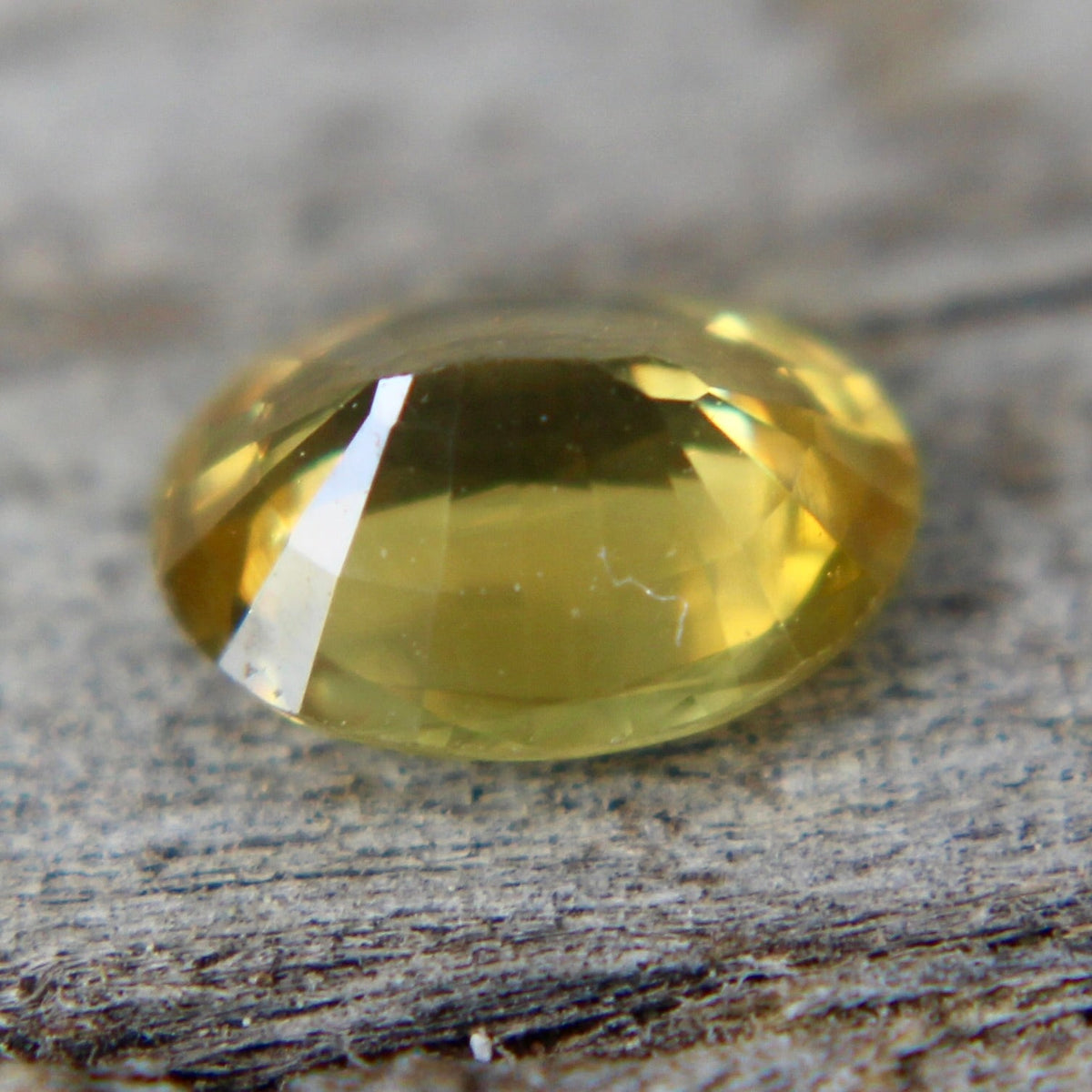 Close-up of an oval yellow sapphire showing its polished facets