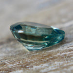 Close-up of the table and surrounding facets of a green sapphire.