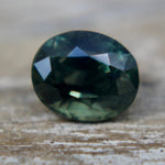 Close-up of the table and surrounding facets of a green sapphire.