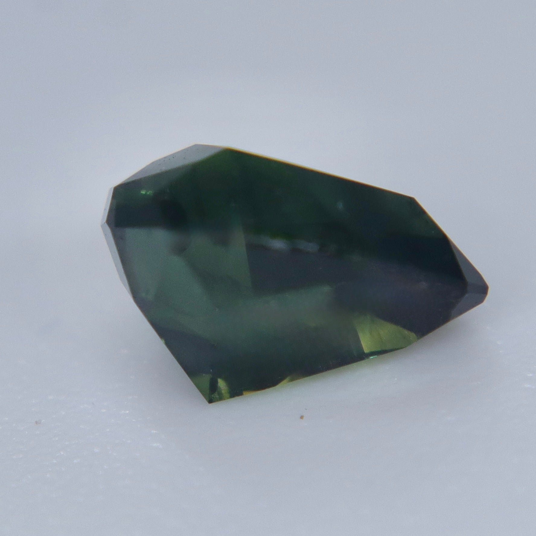 Deep green unheated Australian parti sapphire showing teal flashes, 1.47 carats