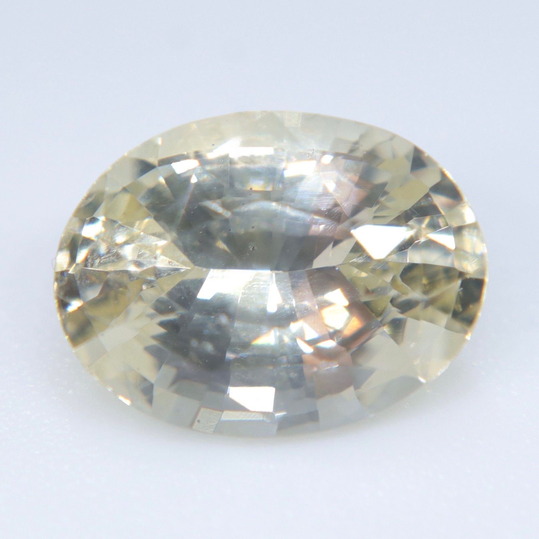 Eye-clean 2.65ct Ceylon yellow sapphire showing faceted crown reflections