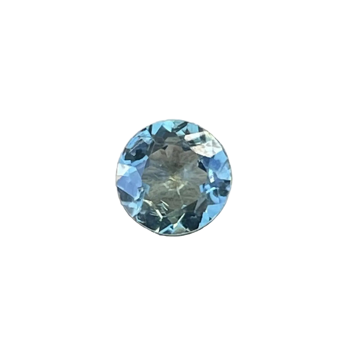 Face-up view of a 0.63 carat natural round green sapphire.
