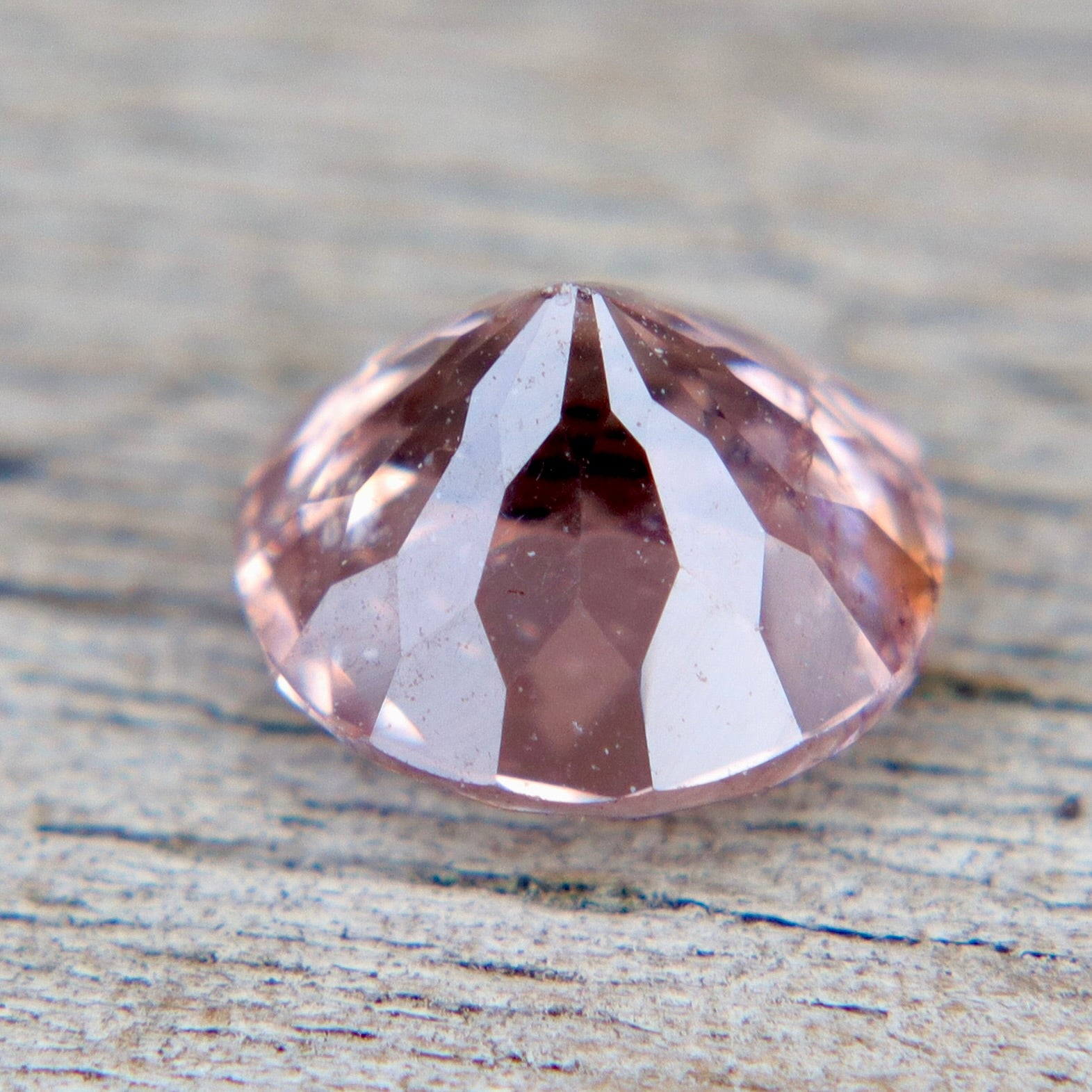 Faceted gemstone on a textured surface