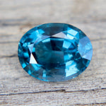 Blue gemstone on a wooden surface
