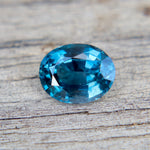 Blue gemstone on a wooden surface