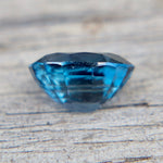 Blue gemstone on a textured surface