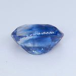 Close-up of natural blue sapphire showing cut and polished gemstone facets and bright sparkle
