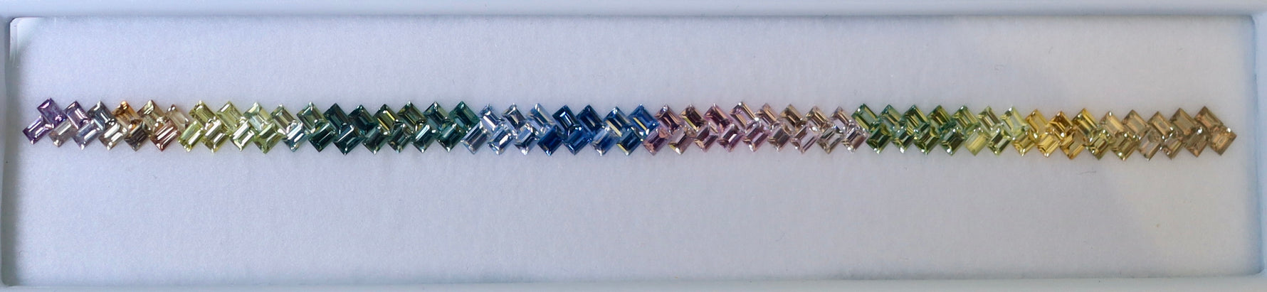 Multicolored braided bracelet on a white box background