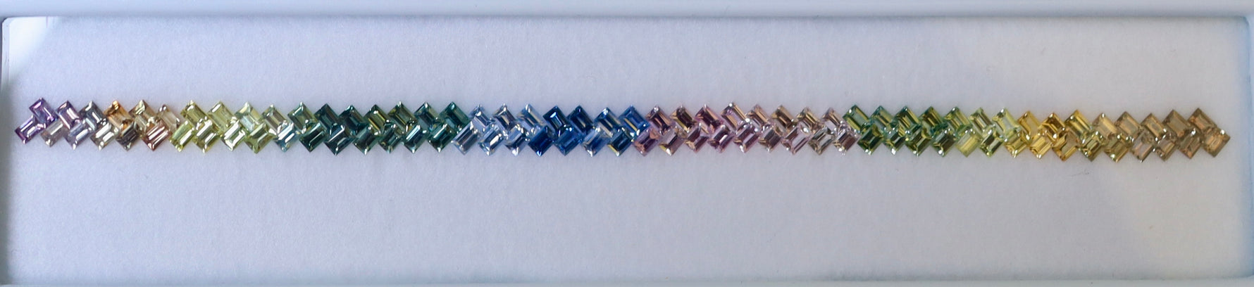 Multicolored bracelet with interlocking hexagonal pattern on a white background