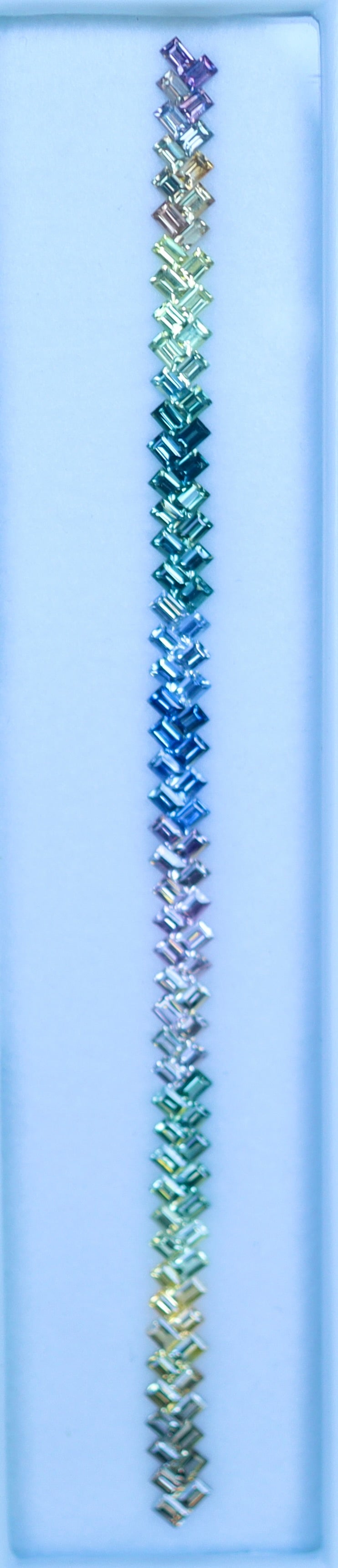 Natural sapphires set photographed in a row for jewelry makers, baguette faceted gemstones (VVS clarity)