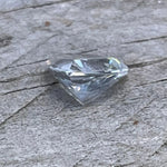 Loose triangular white sapphire measuring 5.95 by 5.85 mm