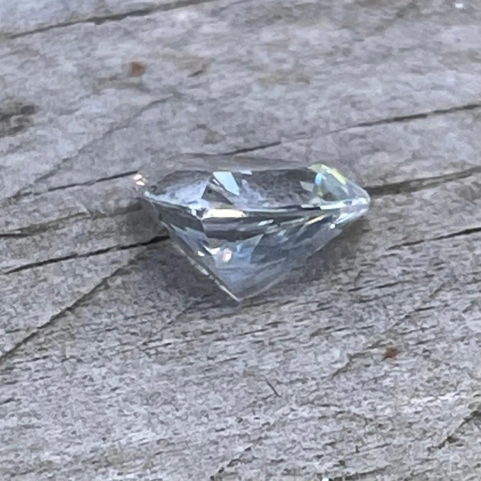 Loose triangular white sapphire measuring 5.95 by 5.85 mm