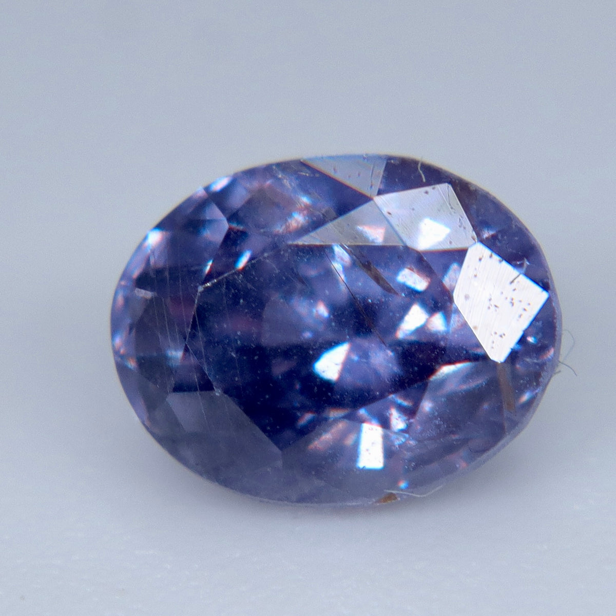 Natural Ceylon purple sapphire viewed face-up with lavender and blue-violet reflections
