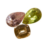 Natural Ceylon sapphire trio with olive green pear, Padparadscha pear and peach cushion gemstones
