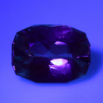 Natural alexandrite displaying a weak color change under warm lighting