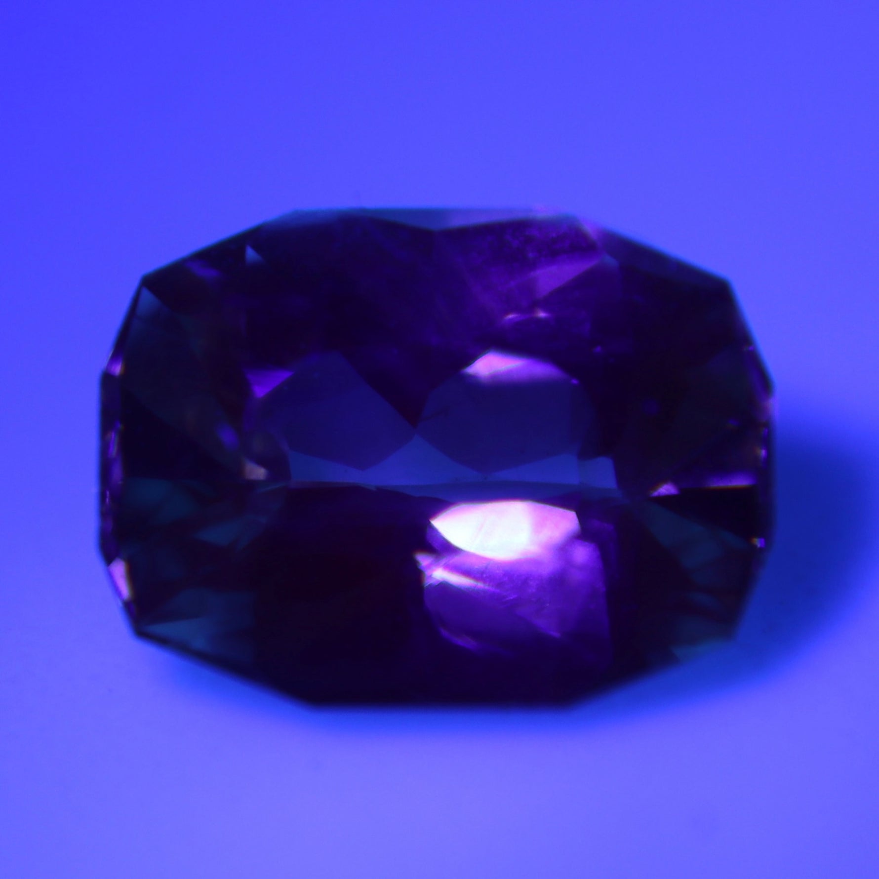 Natural alexandrite displaying a weak color change under warm lighting
