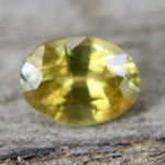 Natural oval yellow sapphire viewed at an angle