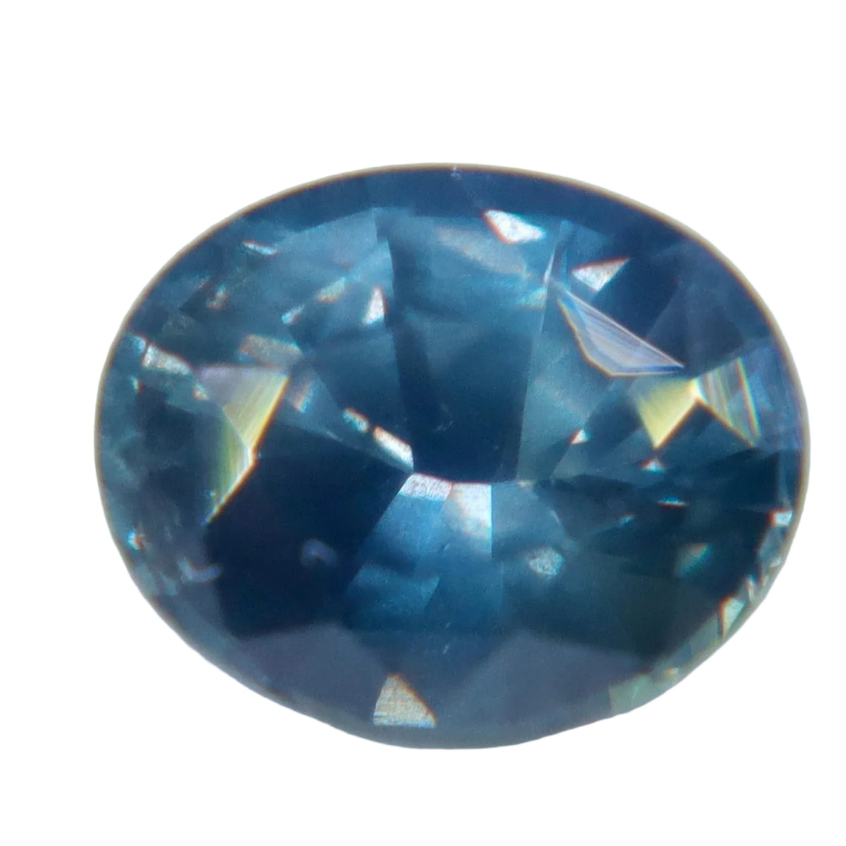Oval Ceylon sapphire with slate-blue facets and muted blue-green reflections, viewed face-up