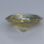 Oval blue-yellow Ceylon sapphire showing its natural color zoning face-up