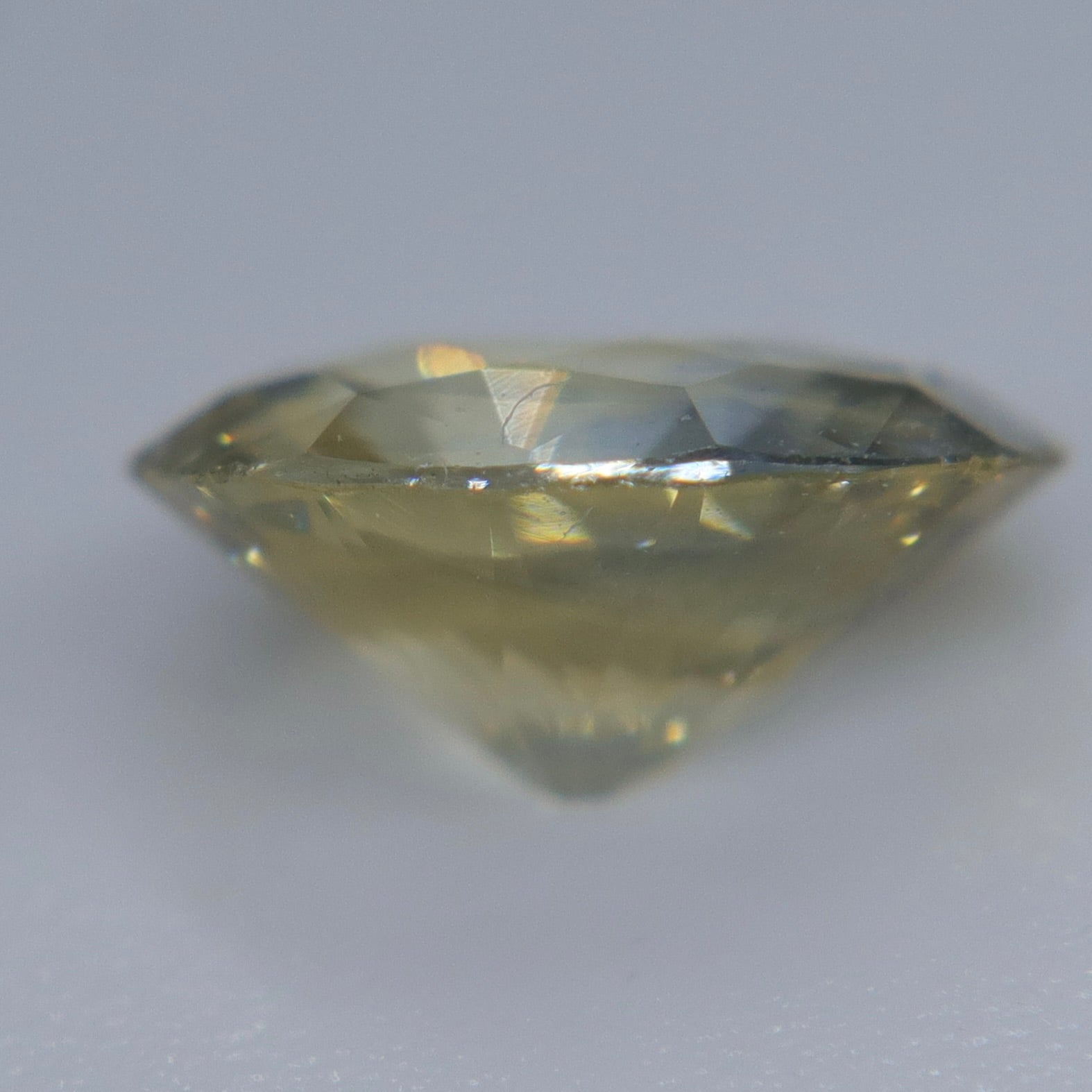 Oval blue-yellow Ceylon sapphire showing its natural color zoning face-up