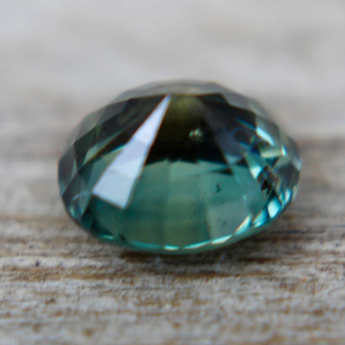 Oval green sapphire from Madagascar showing natural color and visible inclusions