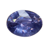Oval purple Ceylon sapphire with lavender reflections and deep blue-violet facets on a pale background