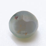 Side profile of a 1.85 ct alexandrite cabochon showing its polished dome.