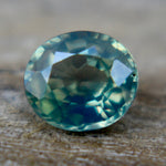 Side profile of a loose oval sapphire showing its crown and pavilion.