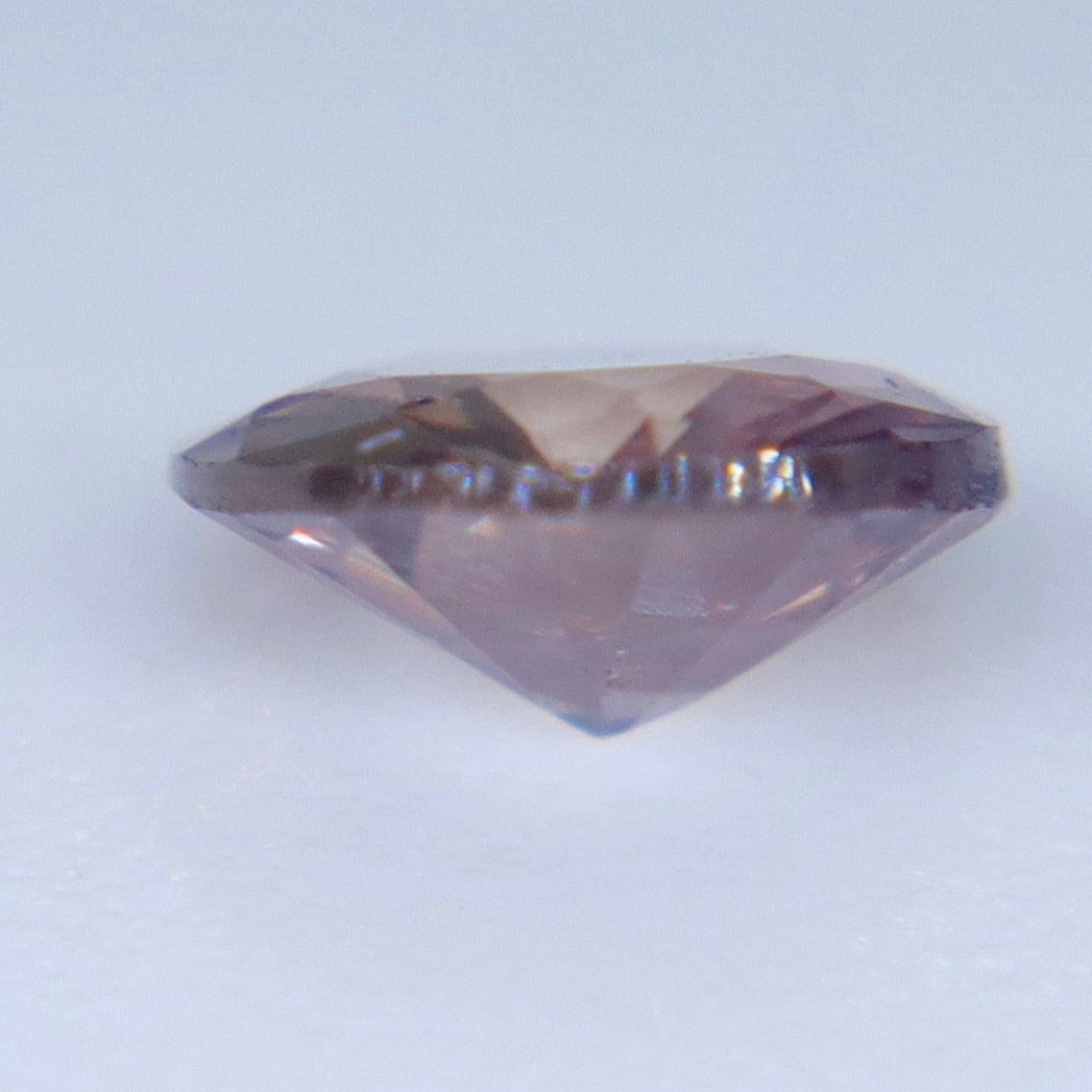 Side profile of a loose roundish oval sapphire showing its 2.30 mm depth