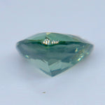 Side profile of a trillion cut green sapphire showing its crown and pointed pavilion
