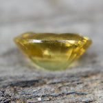 Side view of a loose yellow sapphire showing its 2.66 mm depth