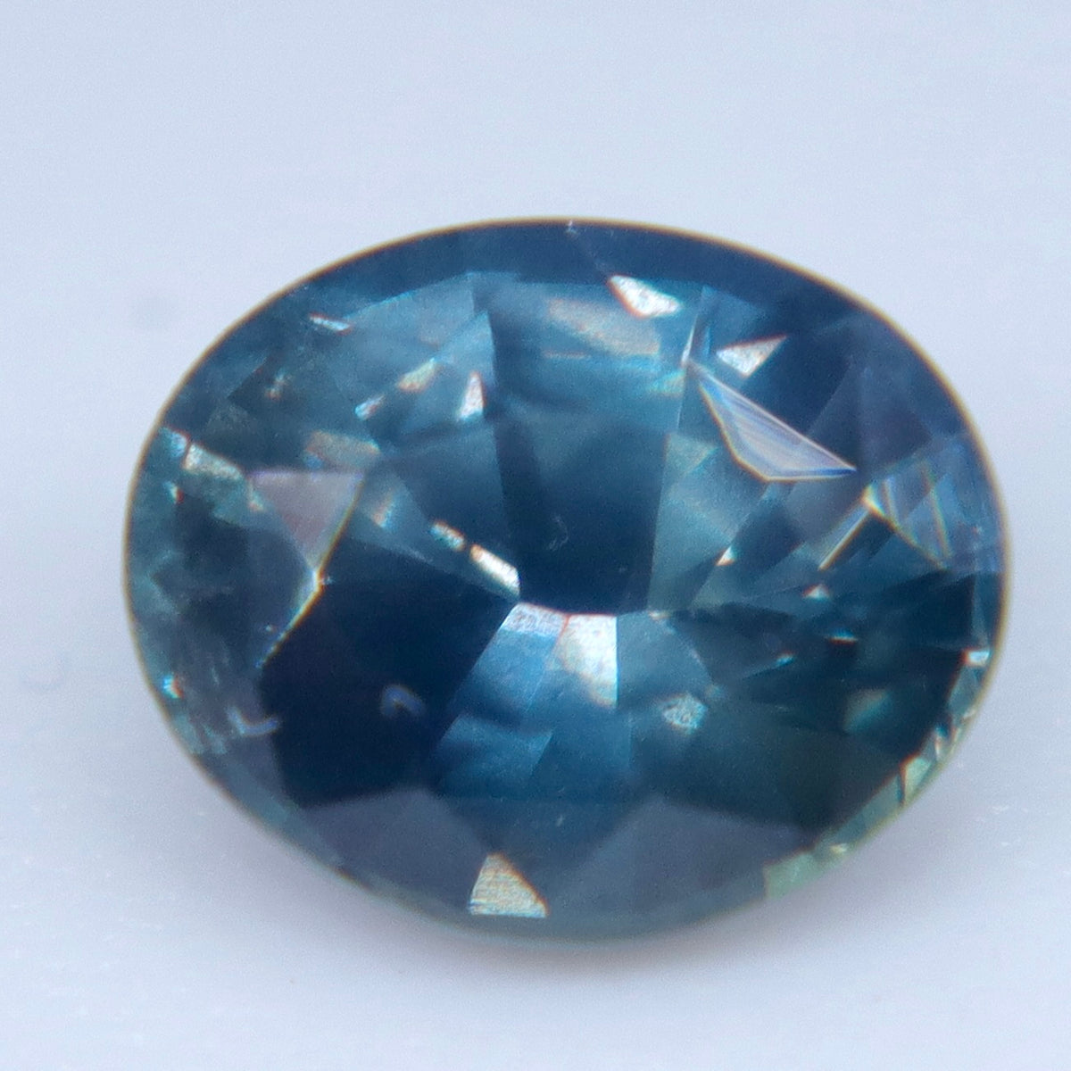 Side view of an oval sapphire showing its pavilion depth and internal features