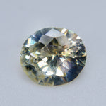Side view of natural oval sapphire measuring 7.63 by 6.84 by 3.76 mm