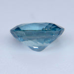 Underside view of a loose teal sapphire showing its polished pavilion facets
