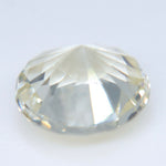 Unheated round white sapphire from Ceylon showing its faceted crown and warm undertone