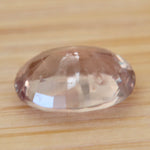 Untreated peach-pink padparadscha sapphire viewed from the front