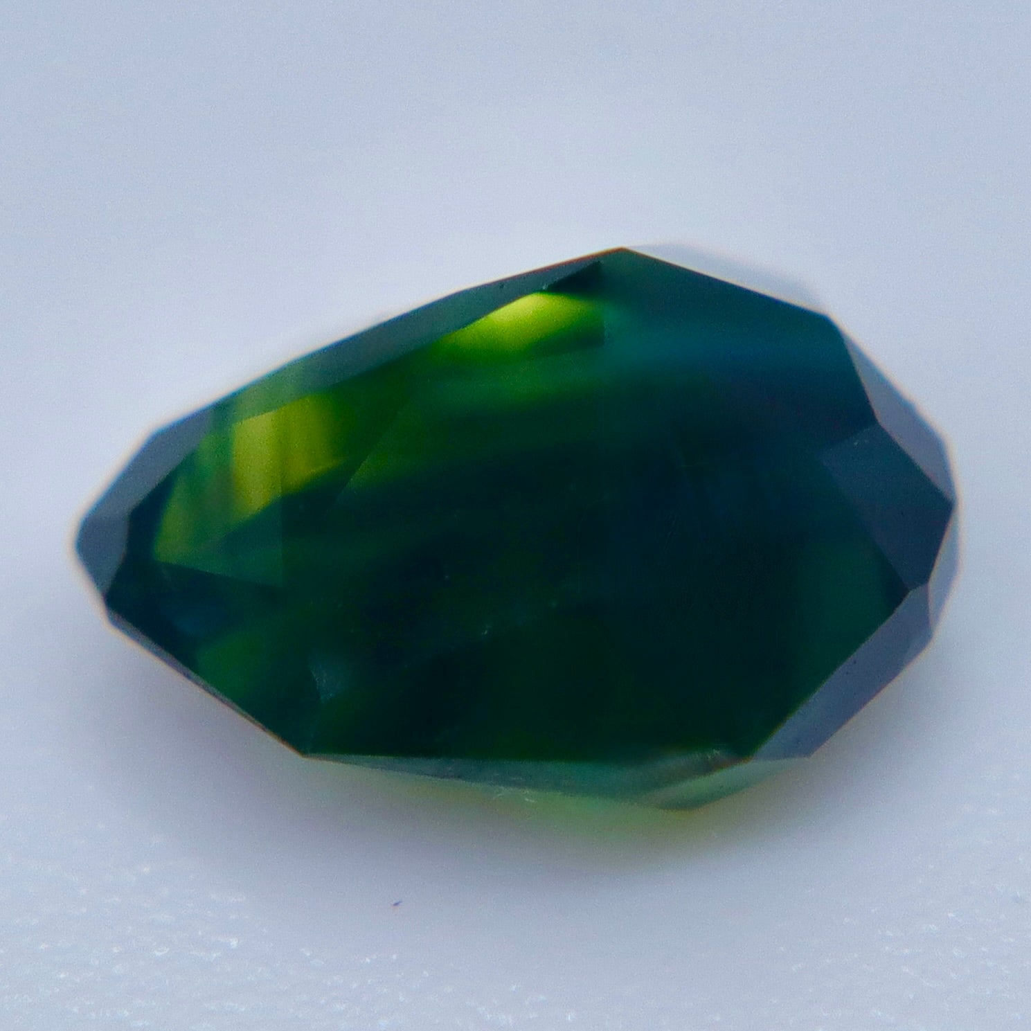 VVS Australian parti sapphire loose gemstone photographed from an angled view