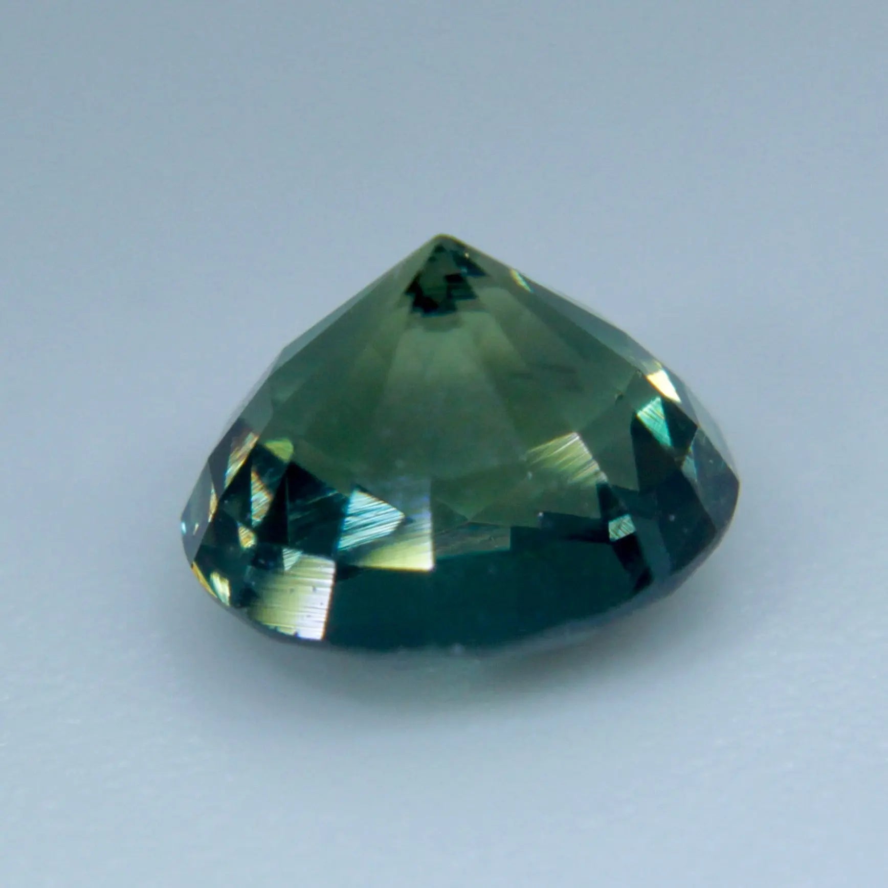 Natural blue-green sapphire measuring approximately 5.96 by 5.65 mm